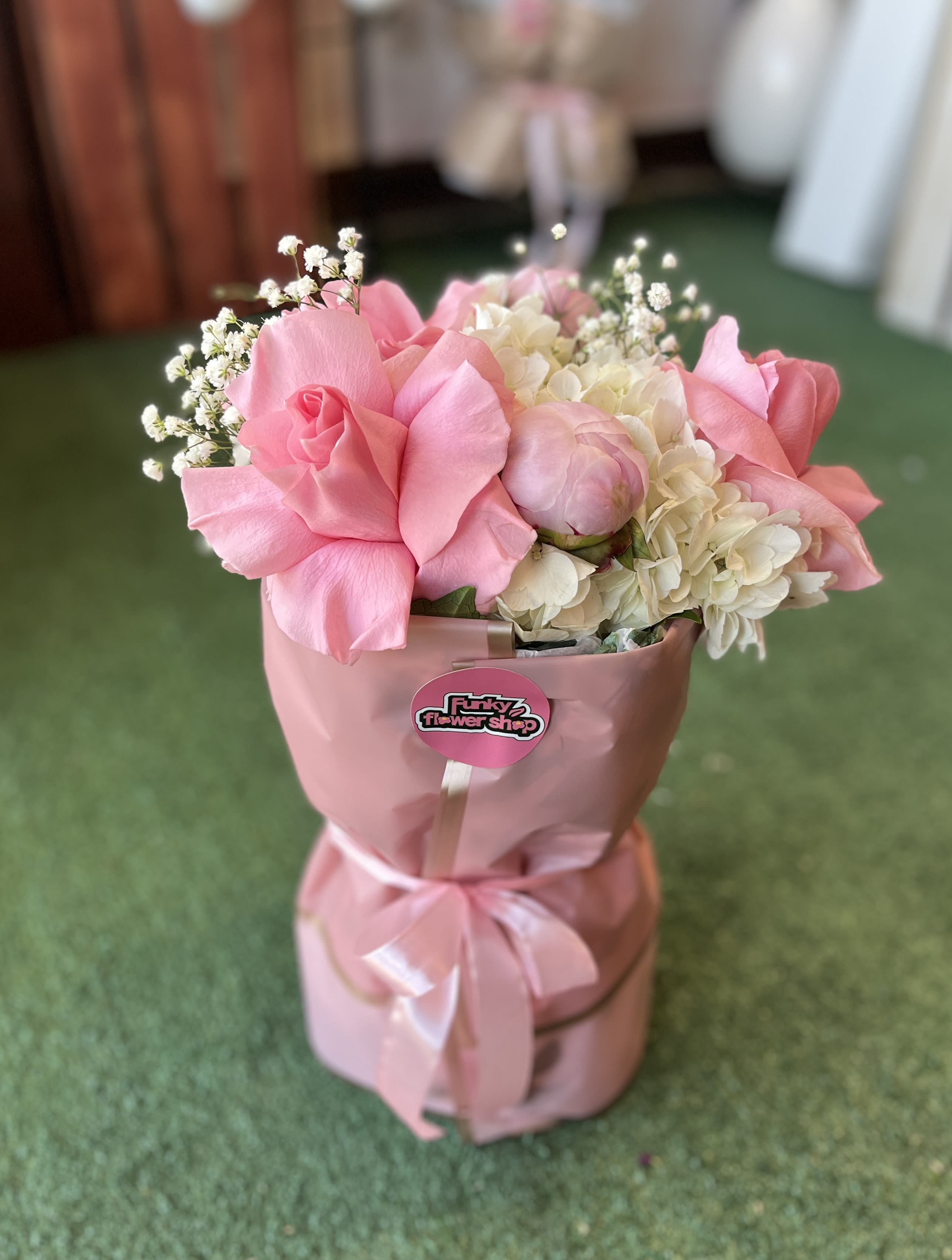 Pink rose bouquet with white hydrangeas in a pink wrapped box