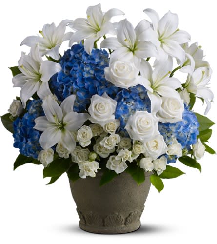  Tranquil Seas  - Say farewell to a beloved friend, family member or business associate with a serene blend of white and blue blossoms, reminiscent of the peaceful sea. This charming bouquet - hand-delivered in a classic urn or basket- will be a thoughtful reminder of your devotion.Color accents or combinations and banner are available.  Please call to discuss. Vessel may vary as needed, can be designed in basket.  A mix of fresh blue and white flowers such as roses, Asiatic lilies and hydrangea is delivered in a Garden urn. basket or vase- let us know!  Call with banner options and accent color requests.  Approximately 19" (W) x 22" (H)      