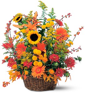 Basket arrangement with sunflowers, orange lilies, and mixed fall flowers