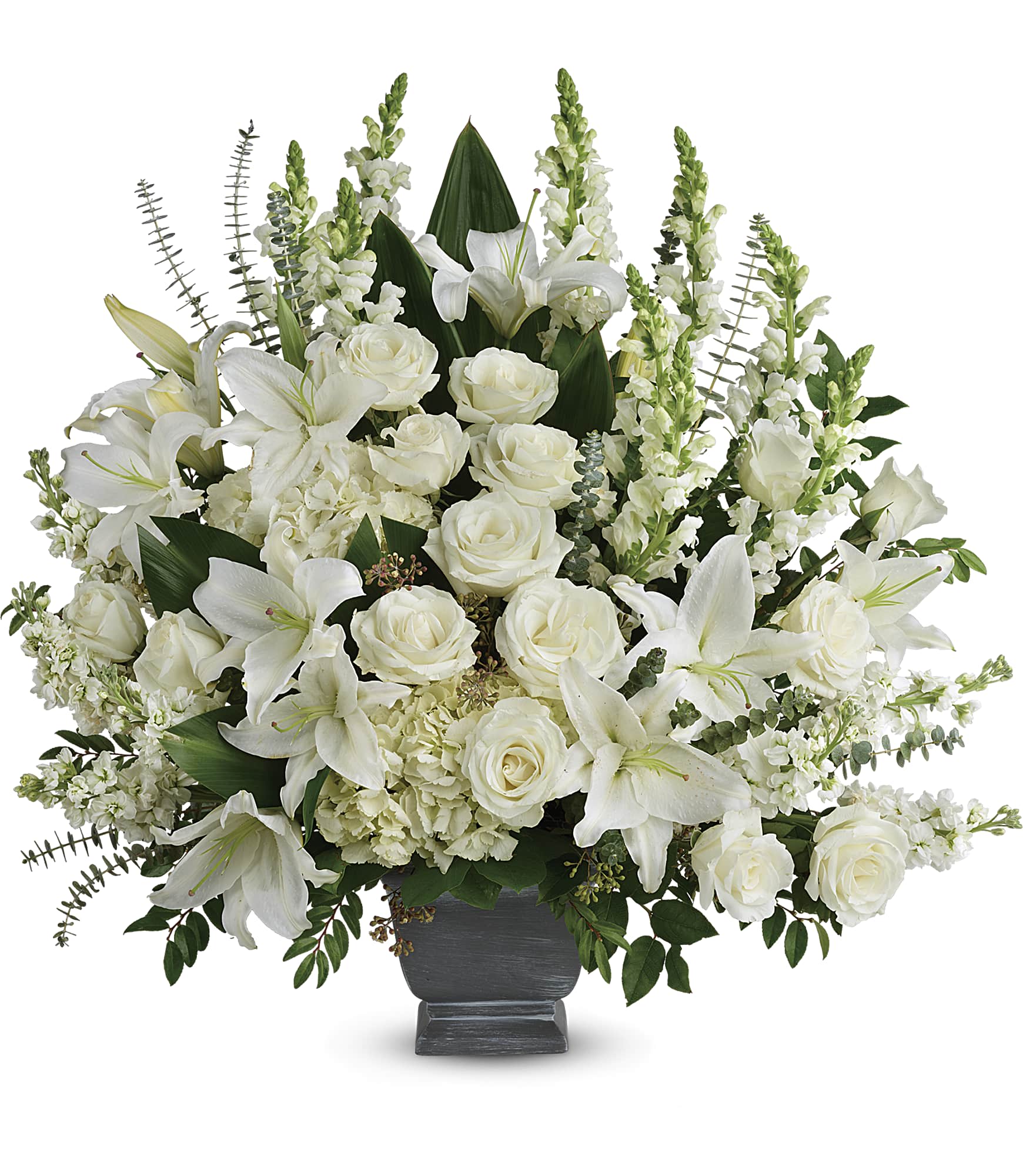 White lilies and roses arranged in a dark urn vase