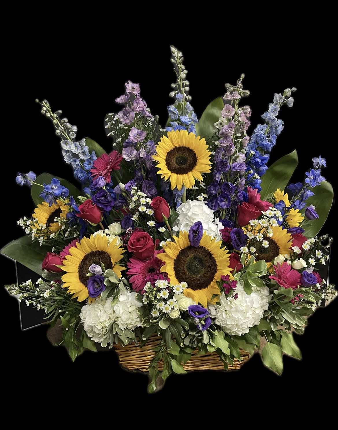 Large basket arrangement with sunflowers, roses, and mixed blooms