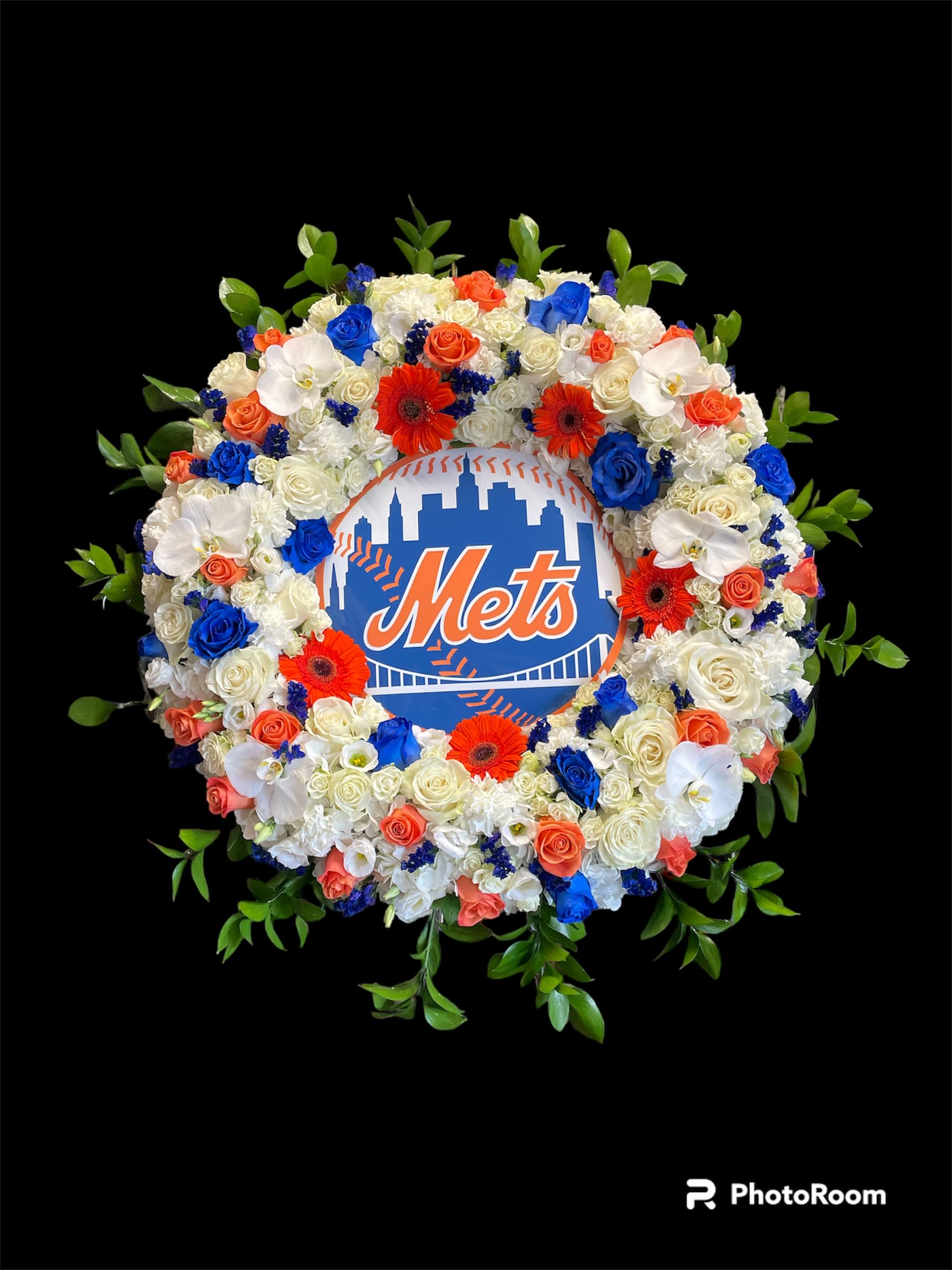 Circular floral wreath around a Mets logo sign