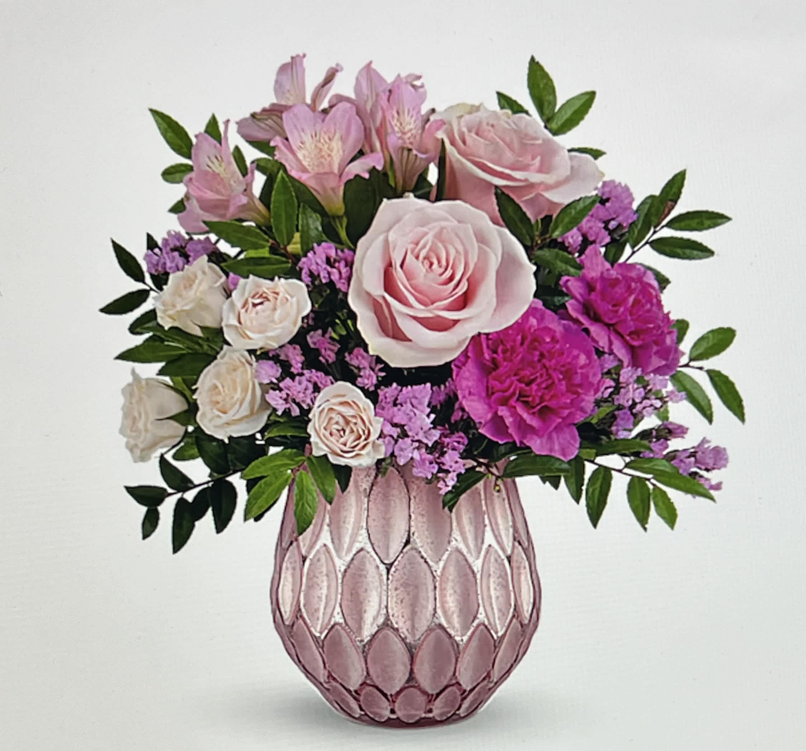 Pink and white flower arrangement in a textured pink vase