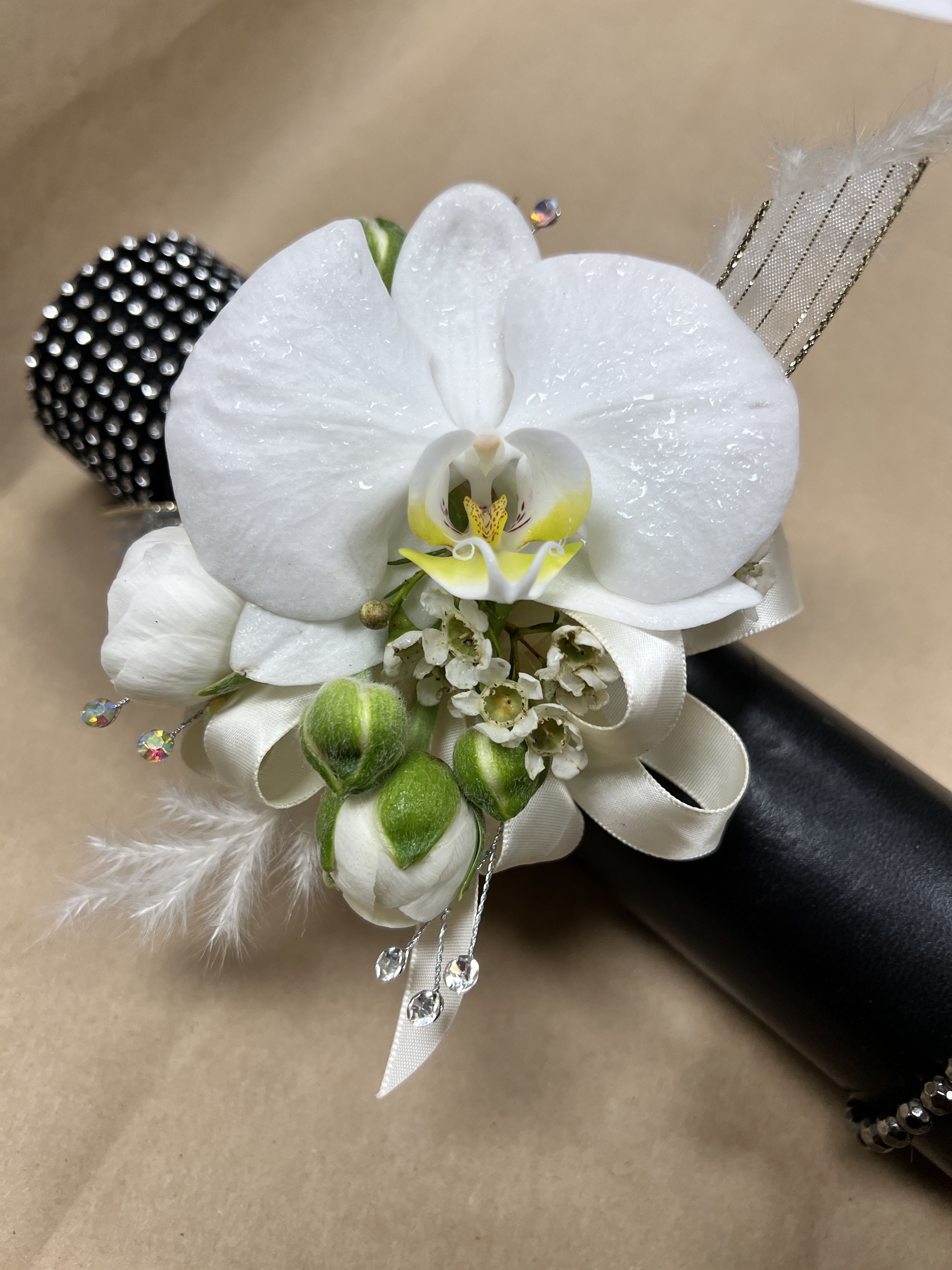 White orchid corsage with ribbon and crystal accents