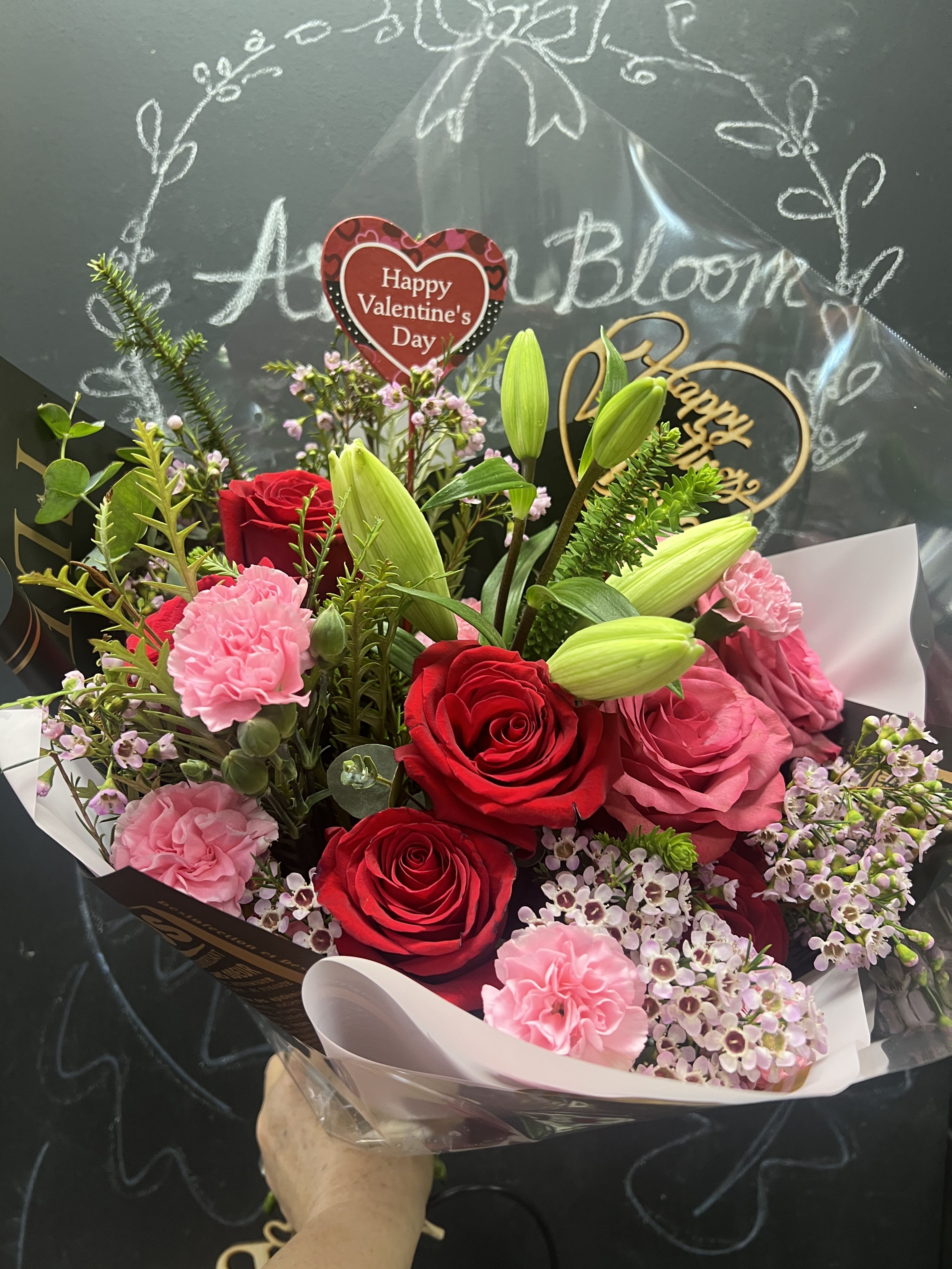 Bouquet of red and pink roses with lilies and carnations