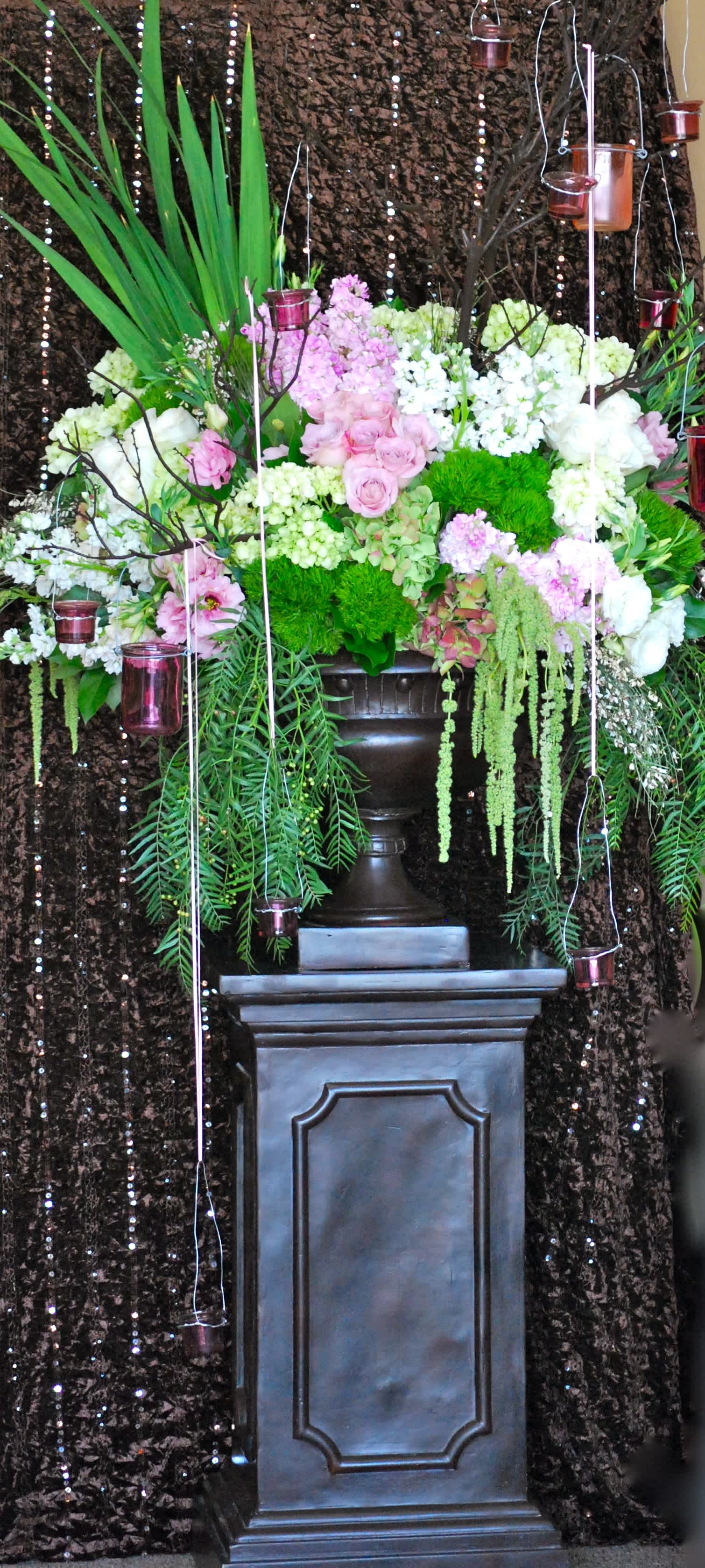 Large floral arrangement with pink and white blooms on a pedestal
