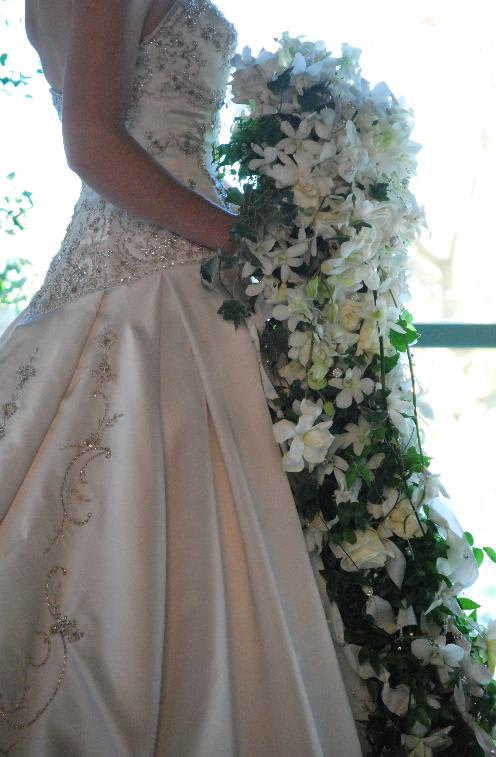 Bride holding a cascading white floral bouquet
