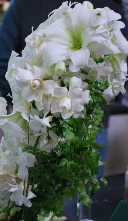 White floral arrangement with cascading green foliage