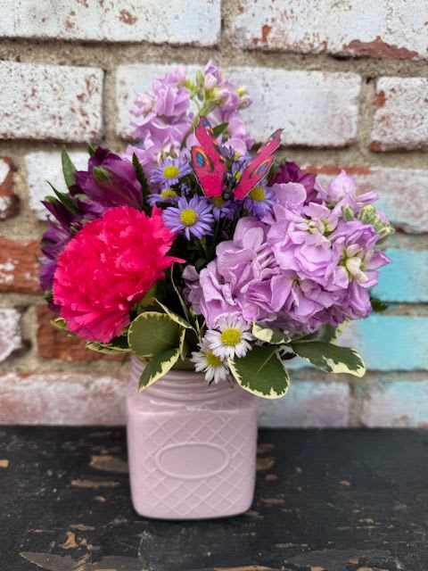 Pink and lavender bouquet in a pale pink vase
