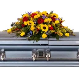 Colorful flower spray arranged on a casket