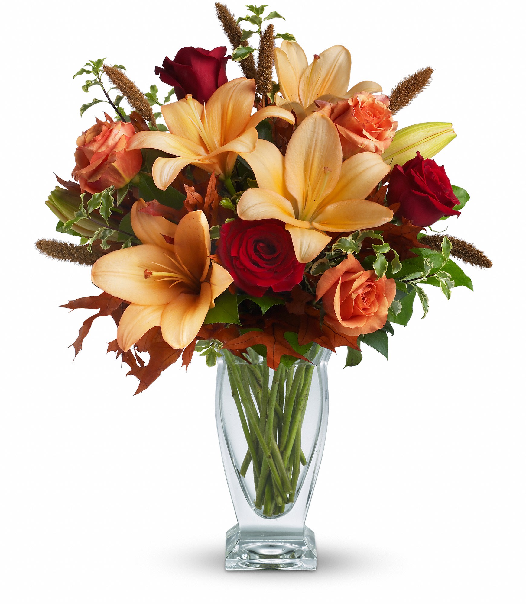 Fall Fantasia - Absolutely exquisite! This bouquet is a fall flower fantasy come true. All the richness of this colorful season is captured in a stylish glass vase. So pretty, you might have to order one for a friend and one for yourself!  Beautiful orange and red roses, yellow asiatic lilies, autumn oak leaves and more are beautifully arranged in an exclusive Couture Vase. Isn't fall fantastic?  Approximately 17" W x 20" H  Orientation: One-Sided  As Shown : T167-1A Deluxe : T167-1B Premium : T167-1C