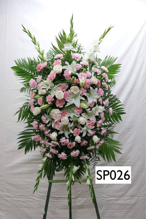 Standing floral spray with white lilies, white roses, and pink carnations