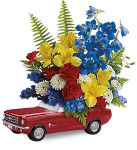 Red toy car filled with colorful flowers