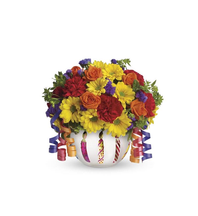 Colorful bouquet in a white vase with curling ribbon streamers