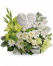 White and green sympathy arrangement with a memorial stone