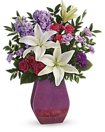 Bouquet of white lilies, pink roses, and purple flowers in a magenta vase