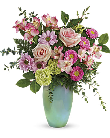 Mixed pink and lavender flowers in a green vase