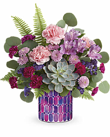 Mixed pink and purple bouquet in a patterned vase with a succulent centerpiece