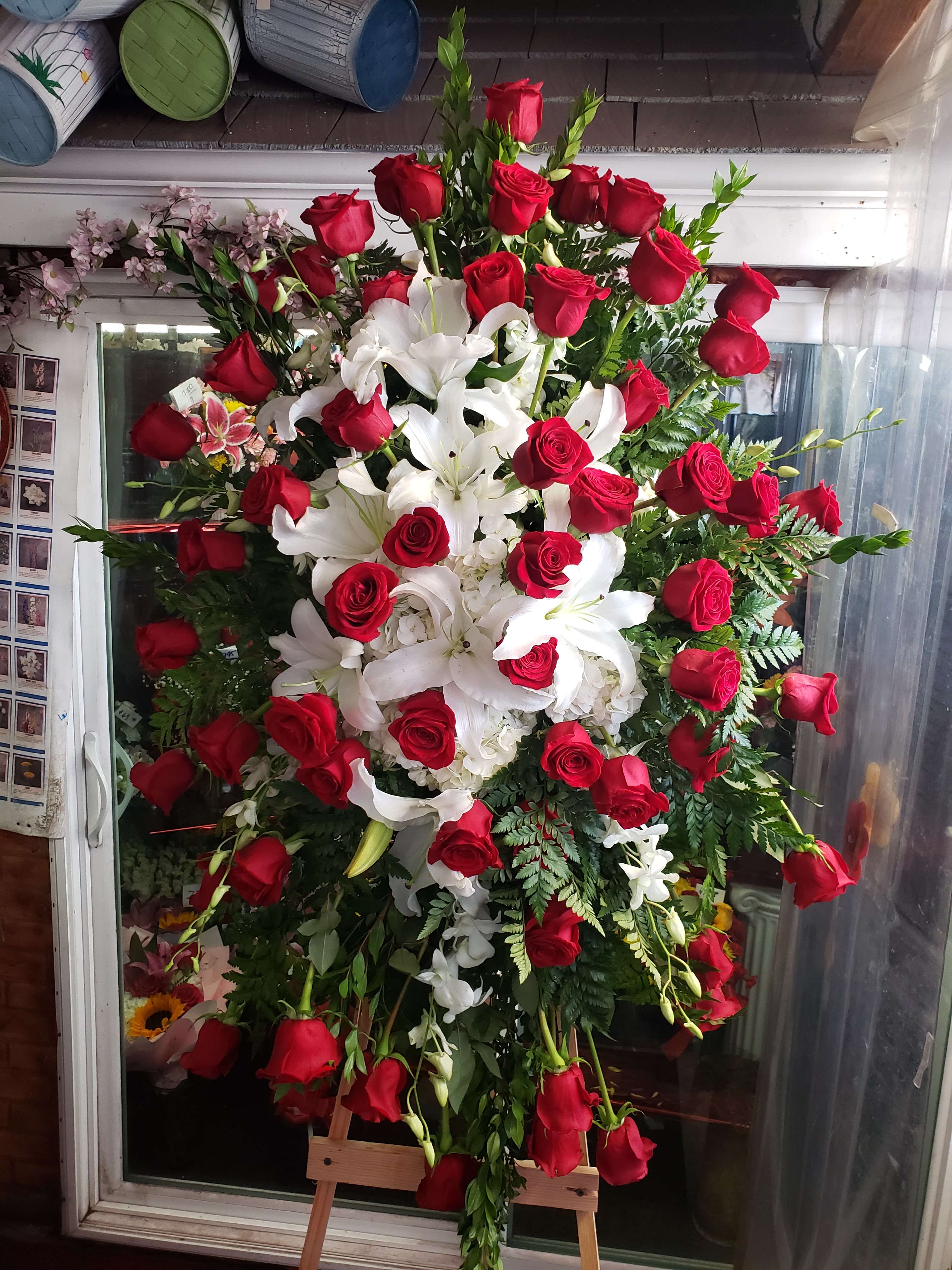 Large standing arrangement of red roses and white lilies