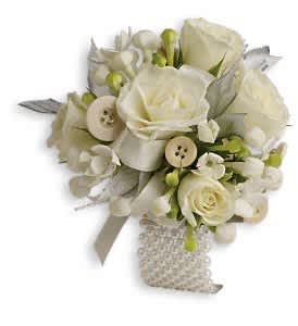 All Buttoned Up Corsage - Delight them all with this romantic arrangement of white blooms and whimsical buttons.  White bouvardia and white spray roses with button accents.  Approximately 4 1/2" W x 4 1/2" H  Orientation: N/A
