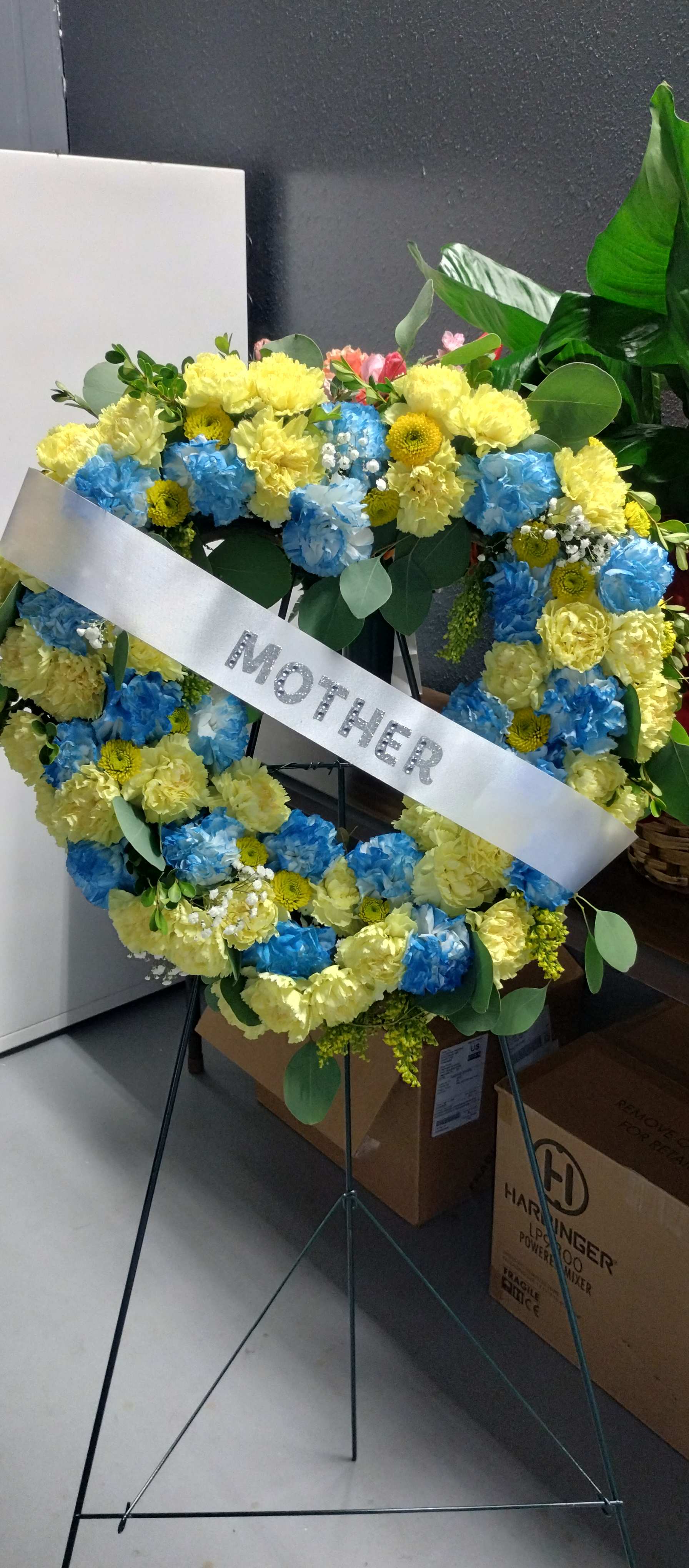 Heart-shaped floral wreath with a silver mother ribbon