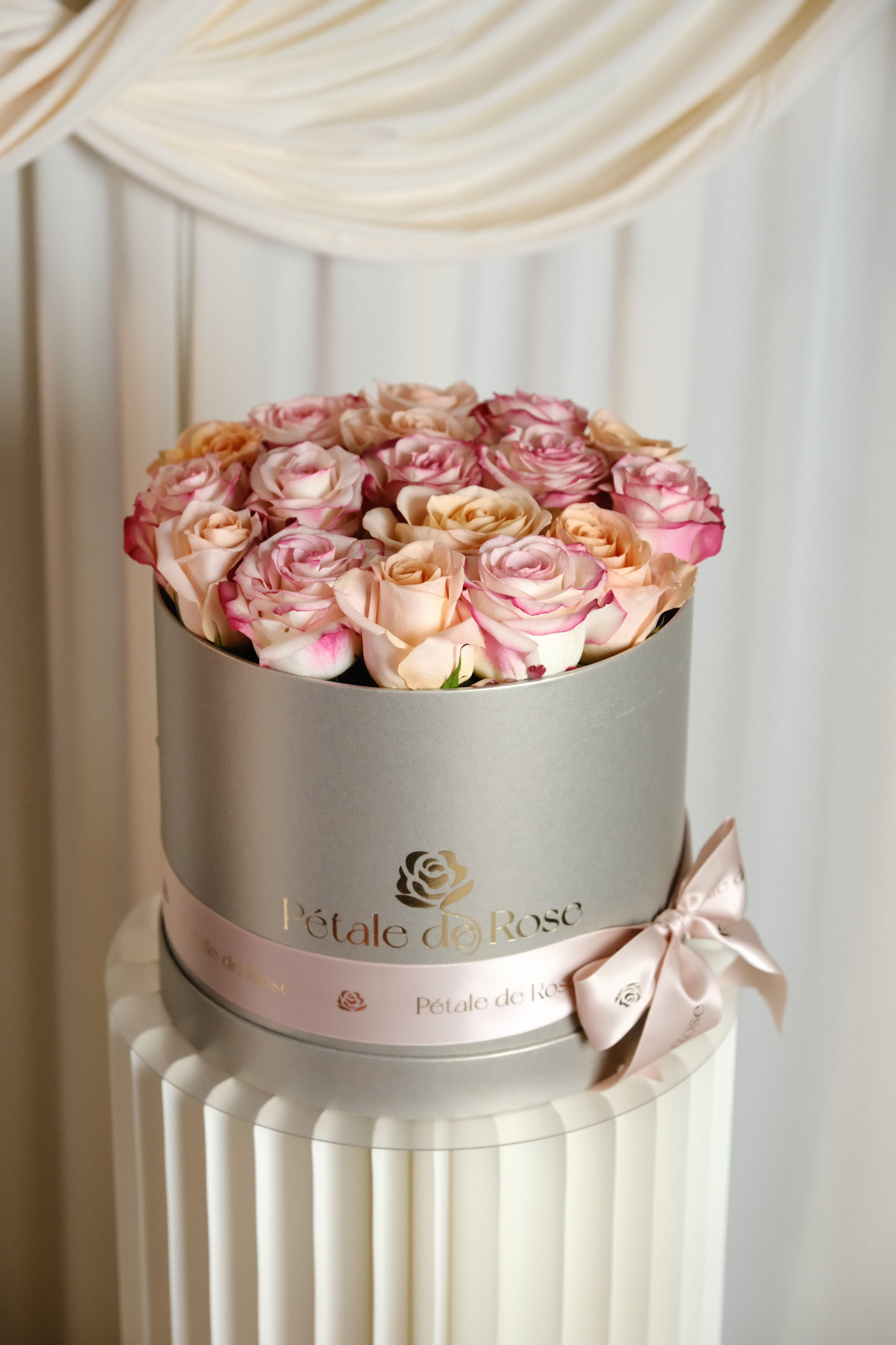 Elsa  - A delicate blend of ivory, and soft pink roses beautifully arranged in our signature new box luxury box.   Elegant and romantic, this timeless floral design is perfect for celebrating life’s sweetest moments and making her feel truly special.  Please note: Flower substitutions and shades may vary based on seasonal and market availability. Our designers will always maintain the overall color palette, freshness, style, and luxurious feel of the arrangement shown. 