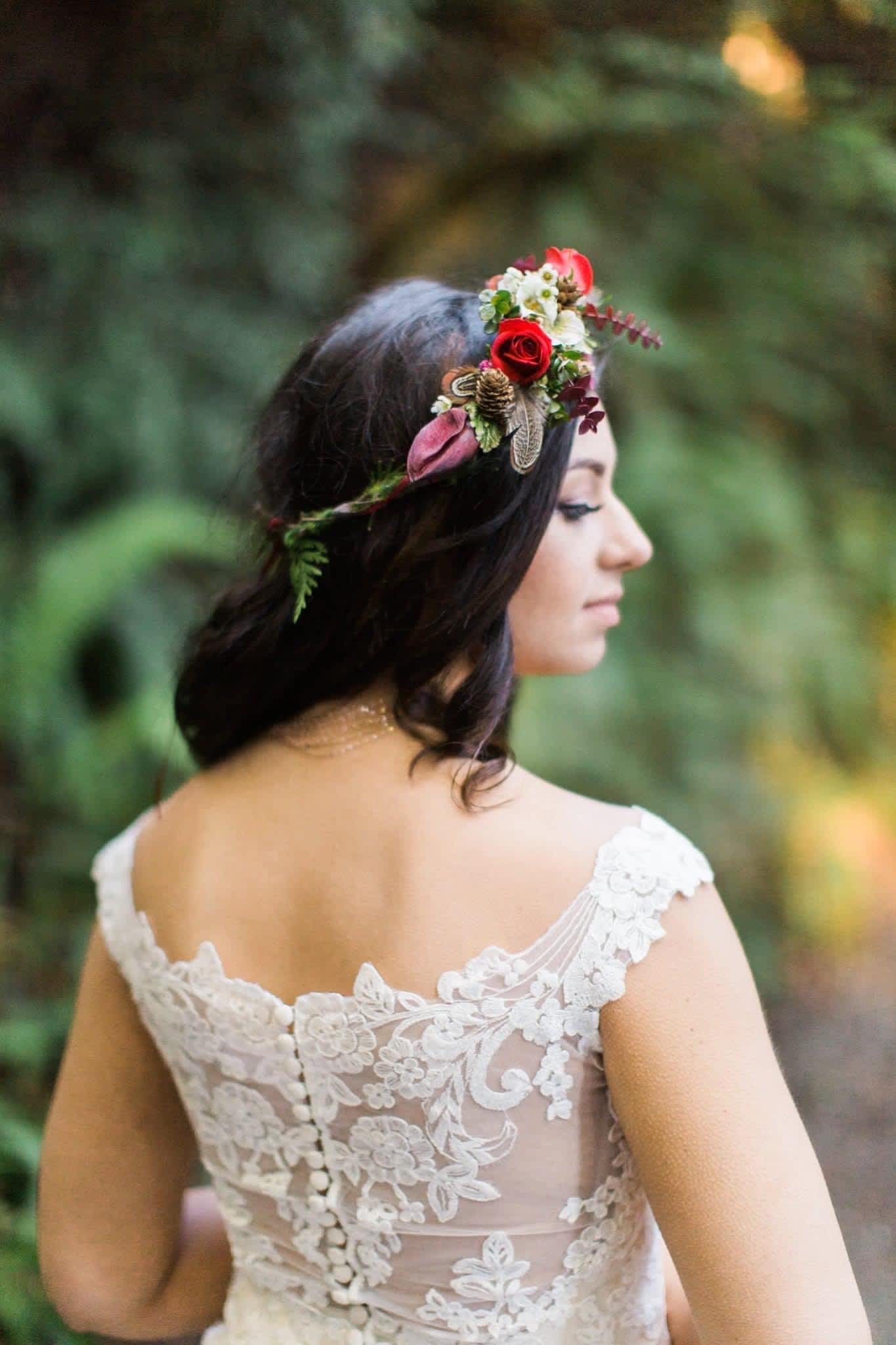 Woman wearing a floral crown with red roses and small white flowers