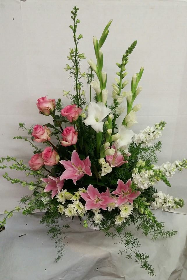 Tall floral arrangement with pink roses, pink lilies, and white gladiolus