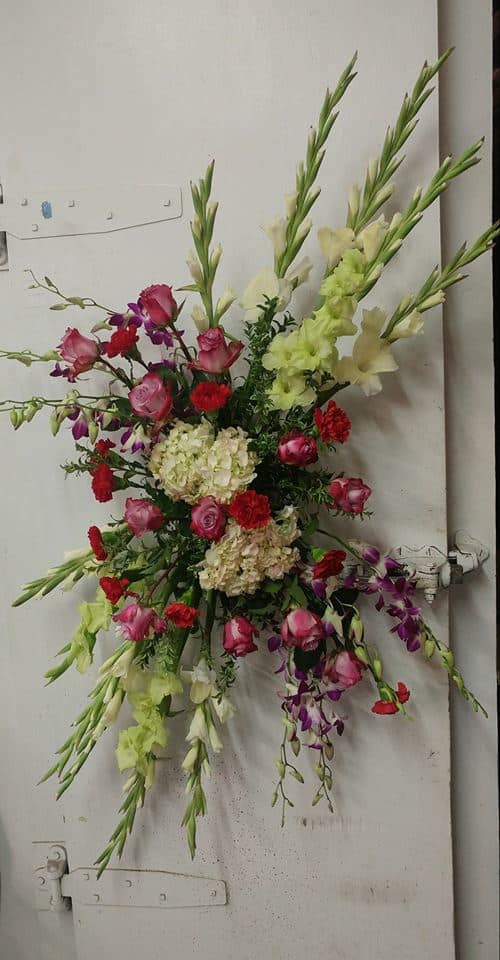 Tall mixed floral spray with pink, red, white, and purple blooms