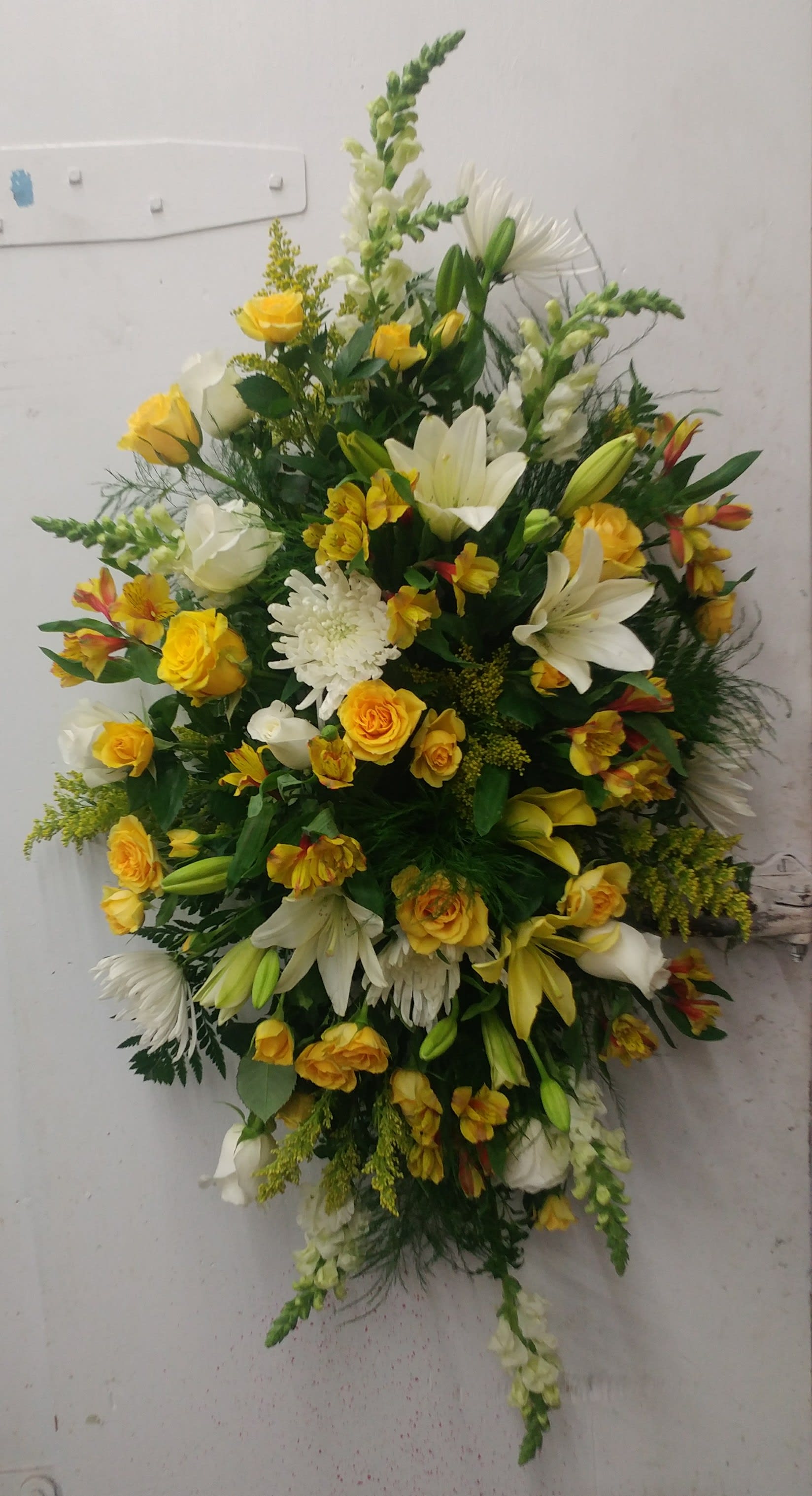Large yellow and white floral spray with lilies and roses