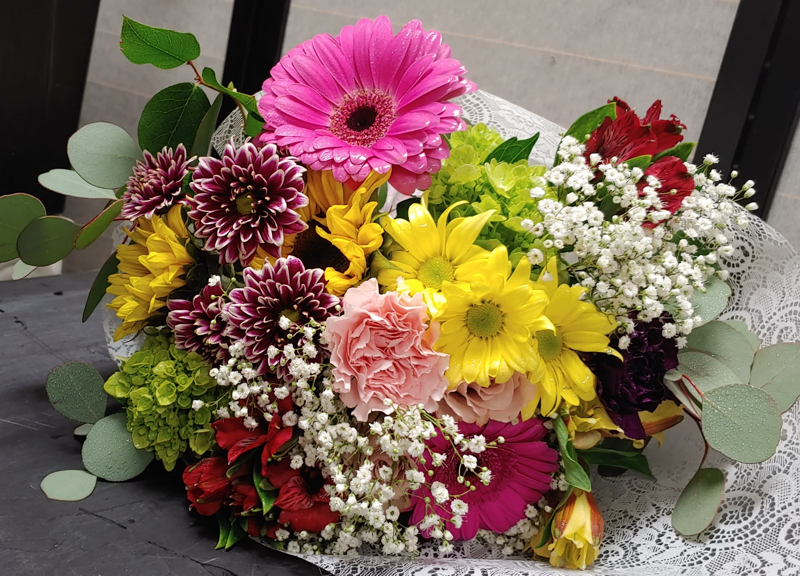 Colorful mixed bouquet with gerbera daisies, carnations, and baby's breath