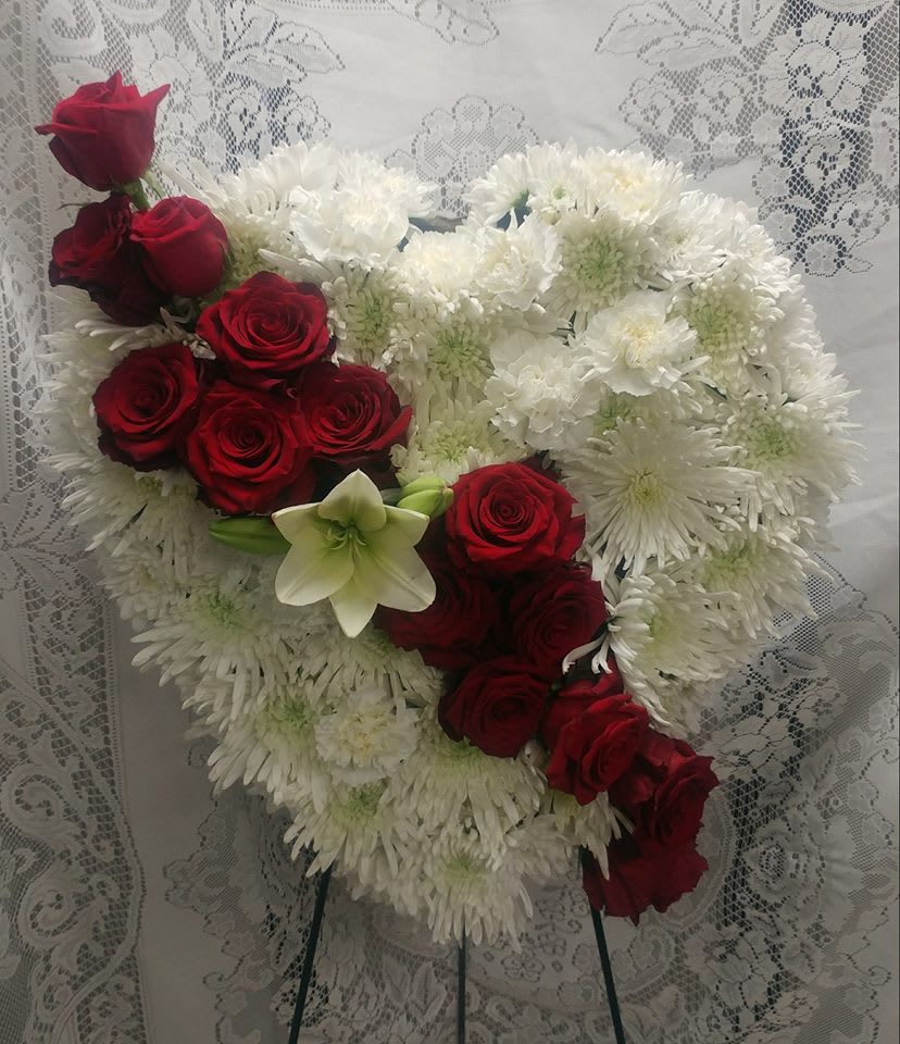 Heart-shaped bouquet of red roses and white chrysanthemums
