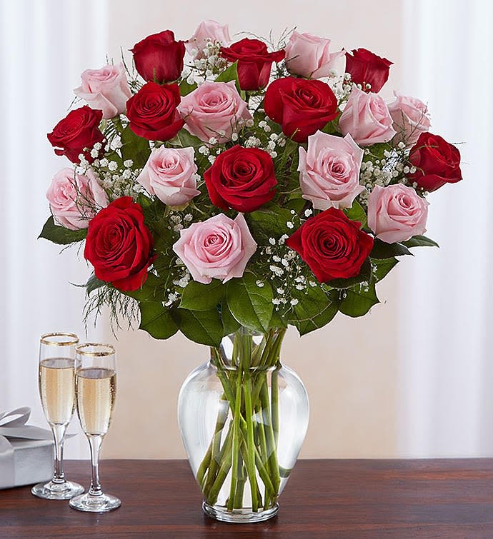 Bouquet of red and pink roses in a clear glass vase