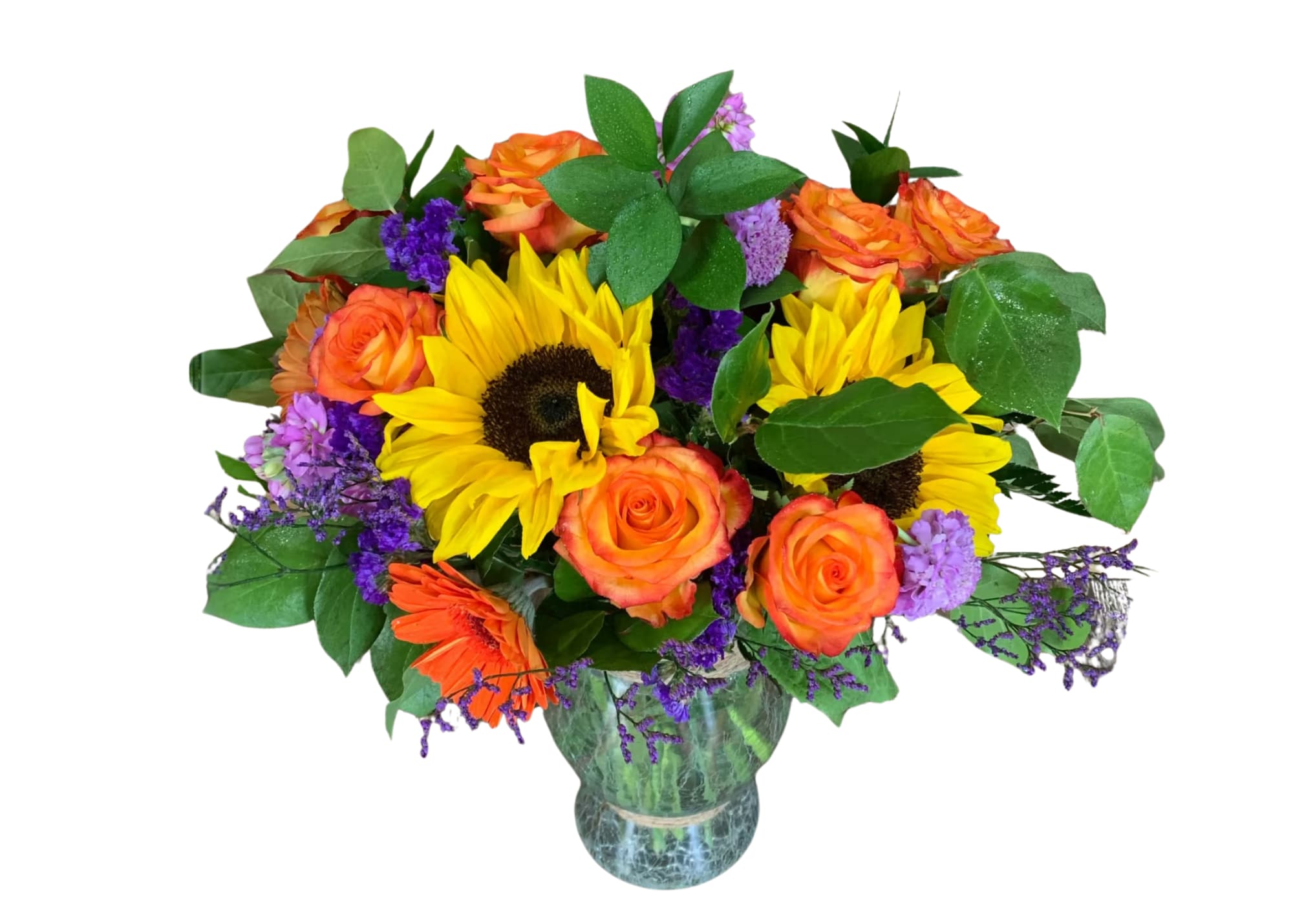 Bouquet of sunflowers, orange roses, and purple filler in a glass vase