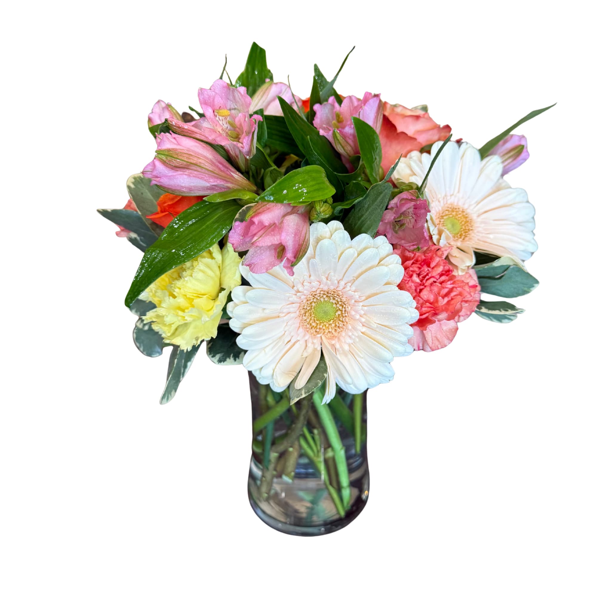 Mixed bouquet of gerbera daisies, alstroemeria, and carnations in a glass vase