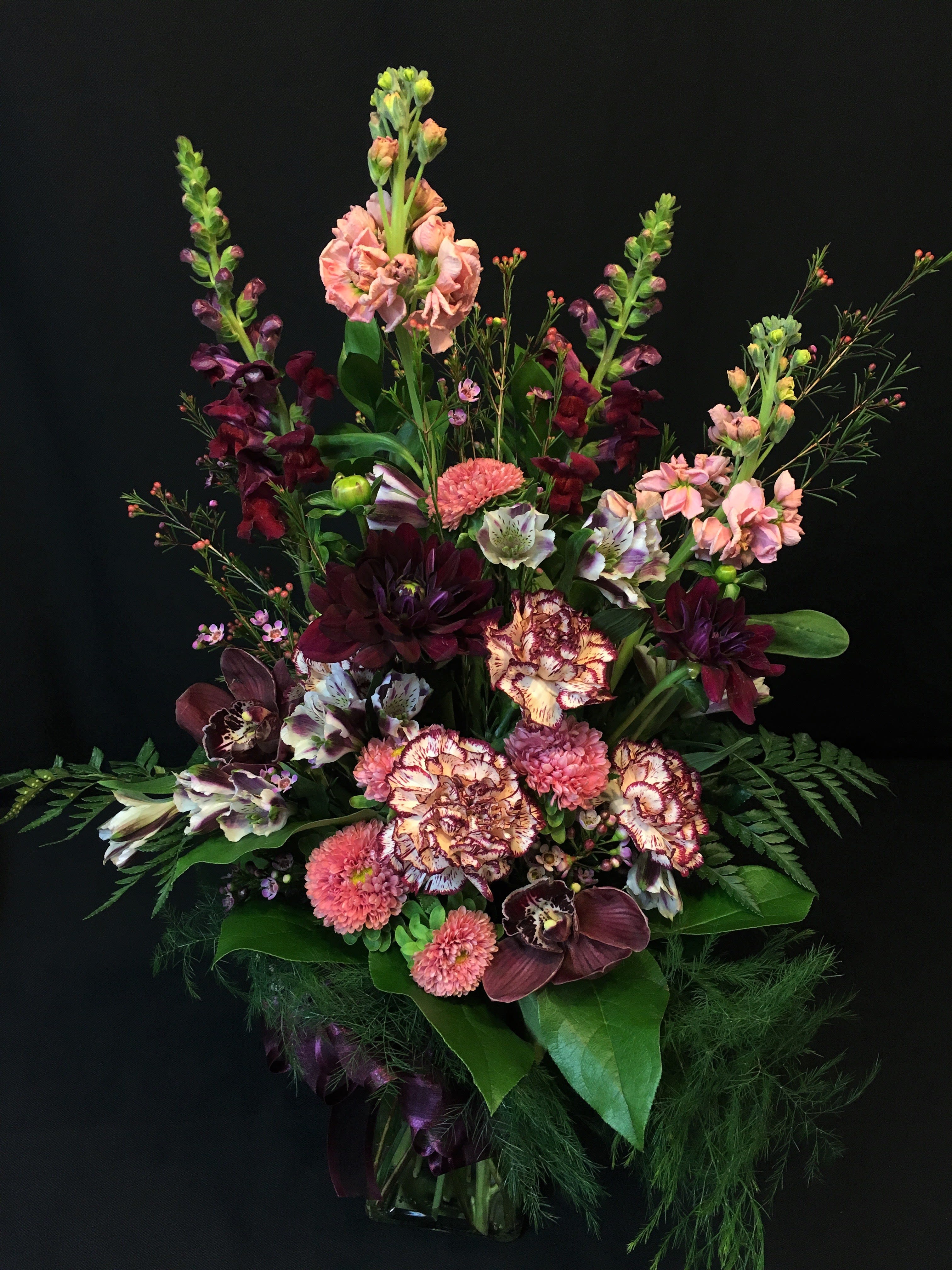 Romantic mix with Orchids and Dahlias - You are a true romantic! This arrangement boasts for you.  Flowers and colors will vary.  We will keep the color scheme in shades of love and romance. Please order at least a week in advance so that we can secure the freshest product for you. Dahlias or orchids may not always be available in which case we will substitute the next best flower.