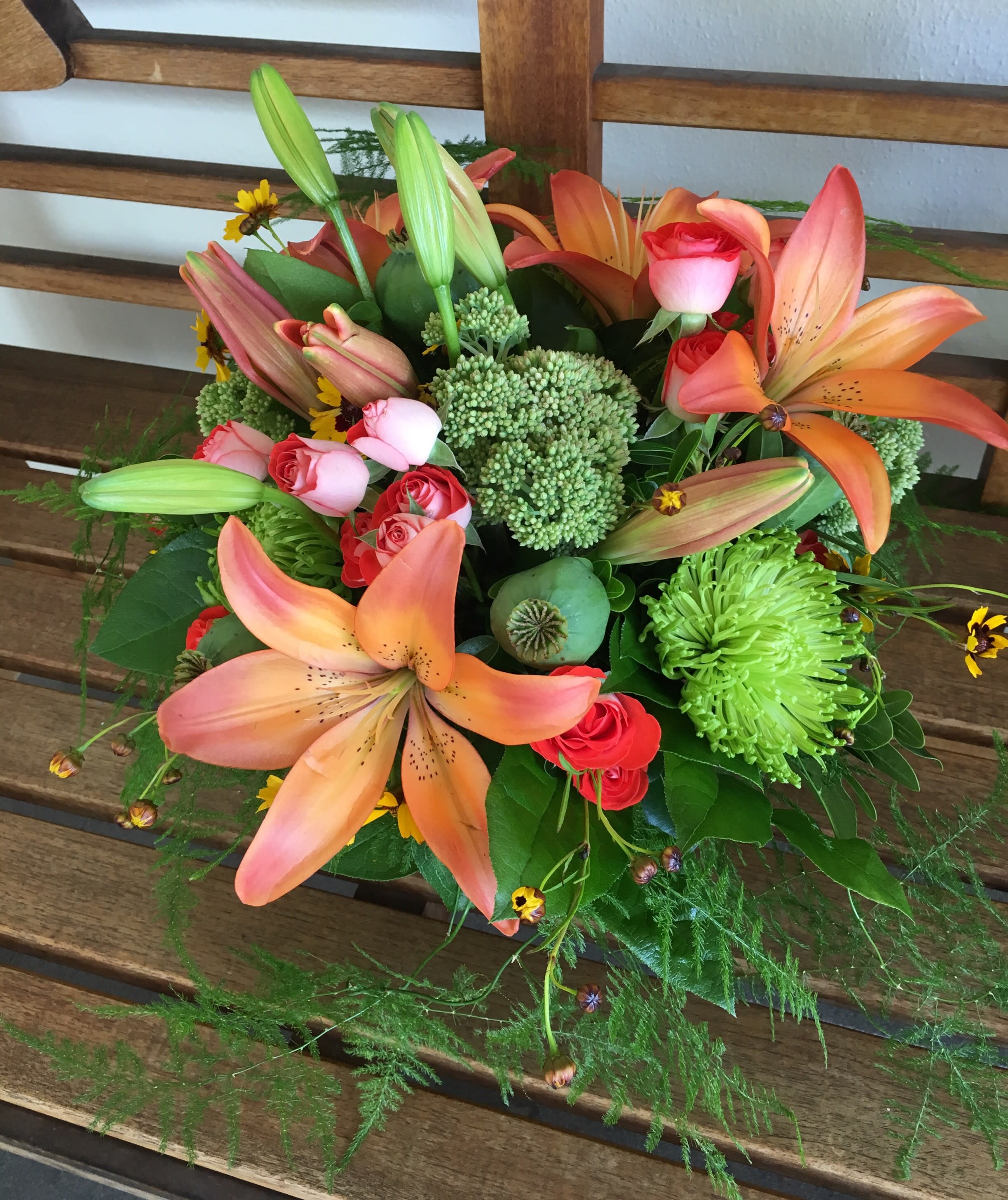 Lily Rose Centerpiece - This vase of lilies, roses and a variety of fun accents is beautiful 360 degrees around so it can be enjoyed as the centerpiece of the room. Colors and accent items will vary. Order at least one week prior to assure these types of flowers.