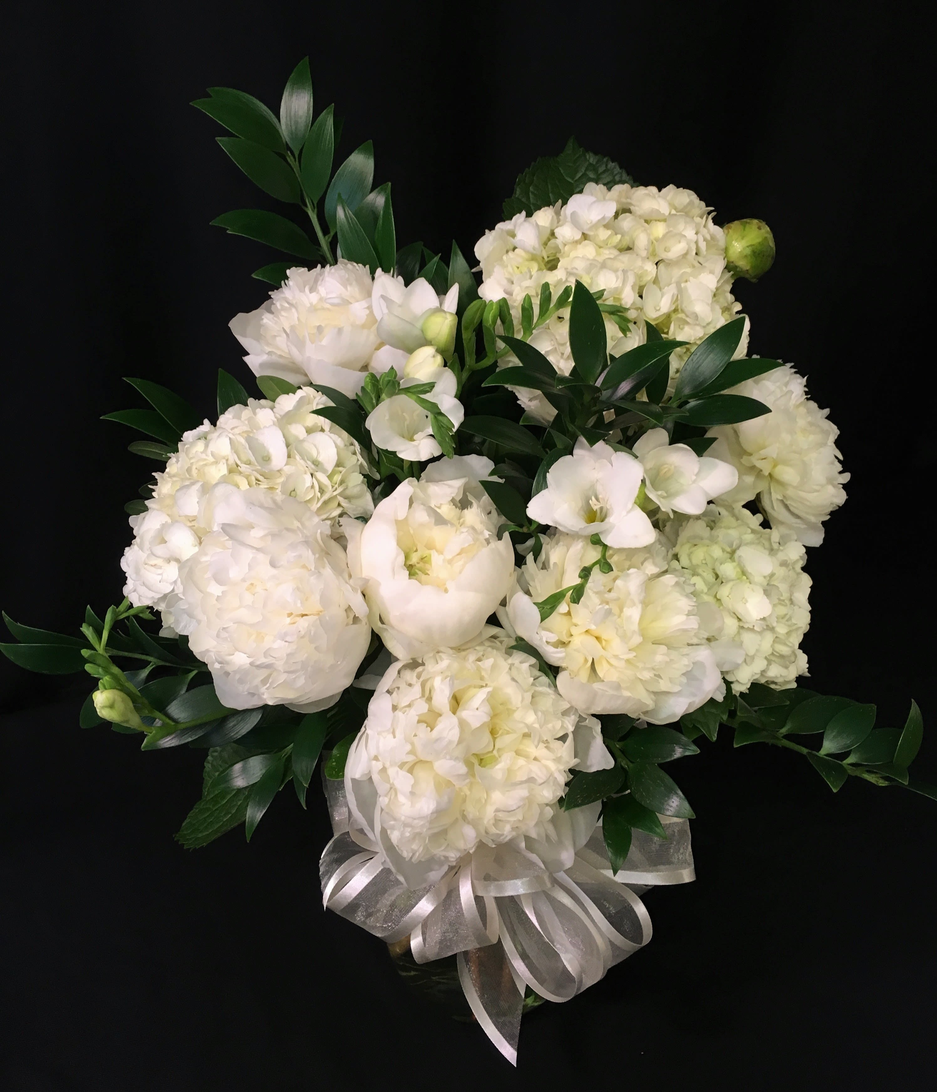Peony vase bouquet with Fragrant Freesia - Stunning white bouquet of creamy peony blossoms and hydrangea. Peonies MUST be ordered well in advance. We frequently have peonies at Christmas, Valentine's day and Mother's day.  However the rest of the year, please provide a minimum of 2 weeks' notice for freshest product to be brought in. We will do our best to get them quicker but can not guarantee it. Other premium flowers may be substituted. Color may vary. Please request all white in the Comments section if that is what you'd like. Thank you. 