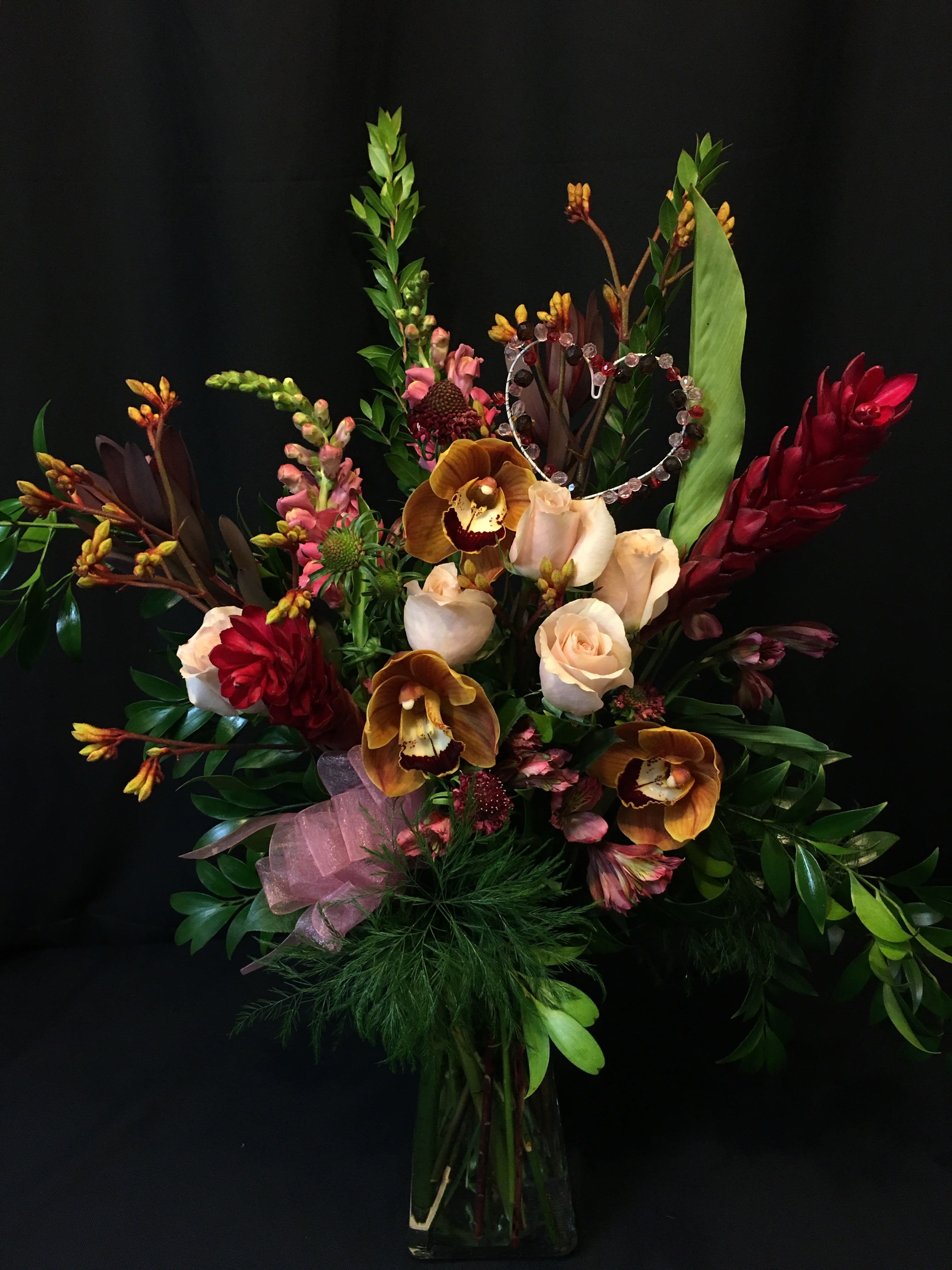 Exotic Rose mix Valentine with Orchids - Sweet display of roses, orchids, exotic foliage and seasonal flowers. Colors may vary.  Premium valentine or anniversary mixed bouquet. Order about a week prior to assure we can get the orchids and exotics in fresh for you, otherwise we will use the closest product that we have in stock.