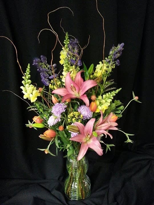 Lily Tall Spring Mix - Recycled glass vase (style may vary) holds a winter / spring assortment. Selection will vary. Elegant botanical design. Can be recreated more or less at any time of year.