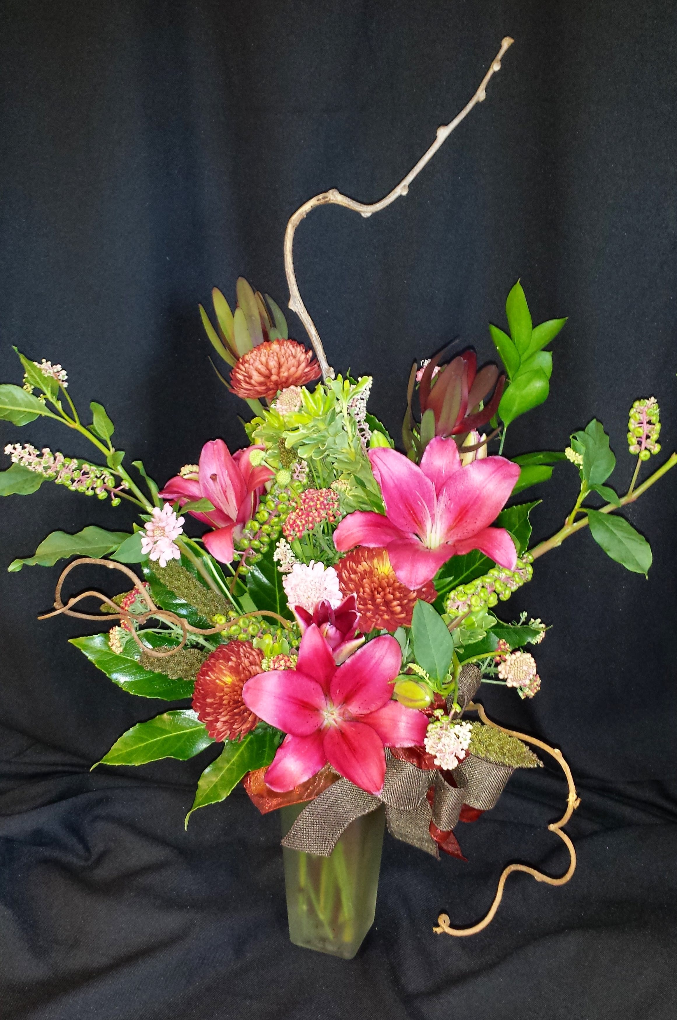 Autumn mix with lilies and kiwi branches - Gorgeous premium Royal lilies, branches and vines will lift your spirits.  A similar style bouquet can be designed in springtime.  Items will vary.