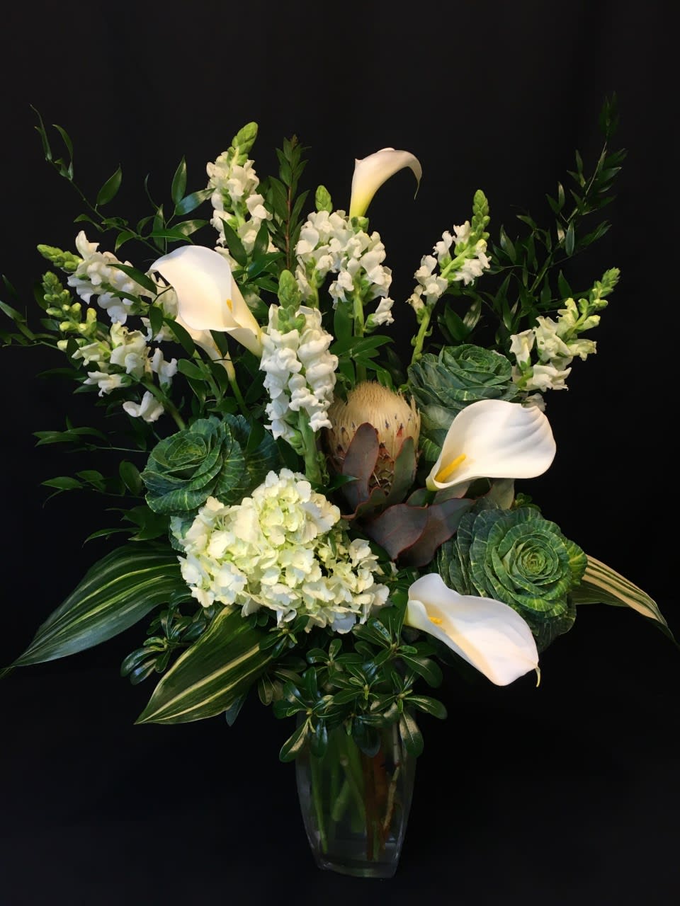 Winter Kale Arrangement - Here is what you order in mid winter when you're still enjoying the clean look of an all white bouquet. Kale, calla lilies and stunning white flowers.  Assortment may vary.