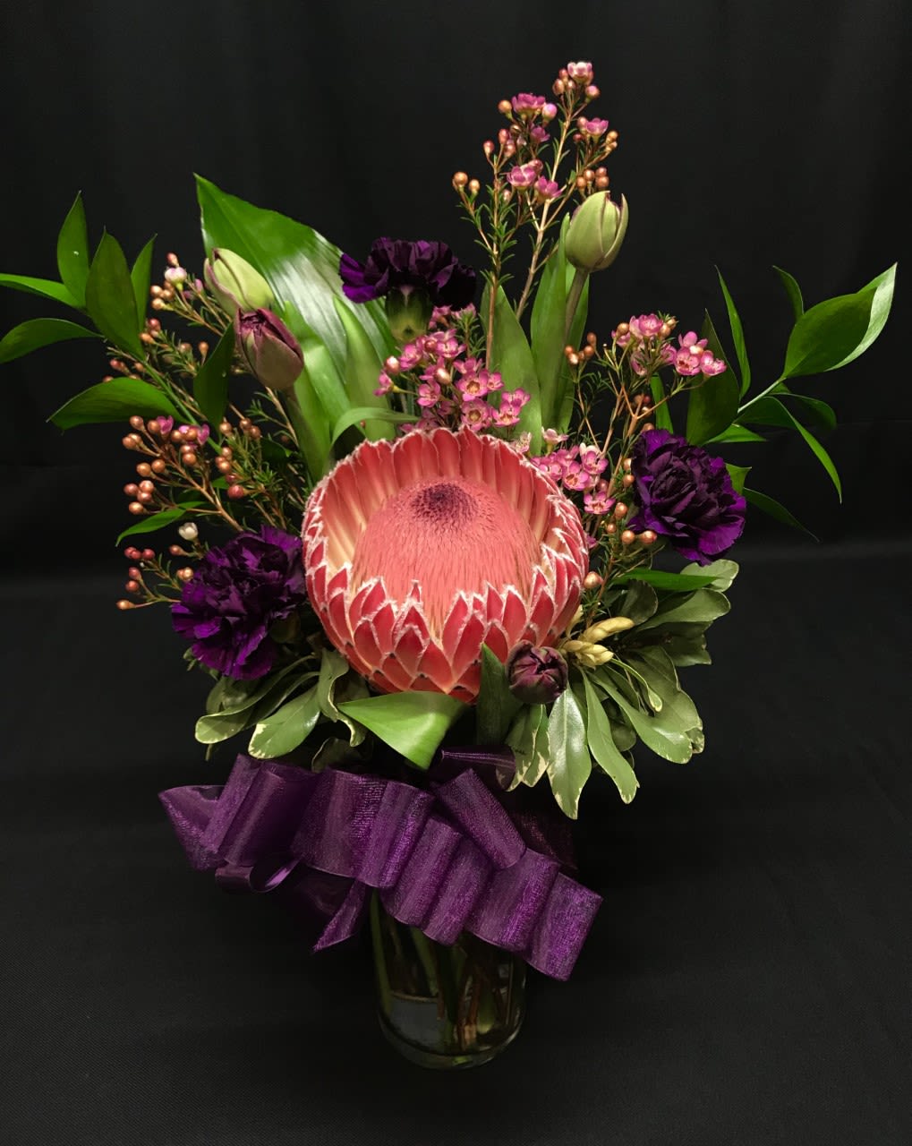 Queen Protea Vase - A smaller exotic bouquet but just as lovely as the rest here.  Big beautiful African protea (exact variety may vary) with an assortment of complimentary flowers. Order ahead as we cannot get the exotic protea at the last minute!