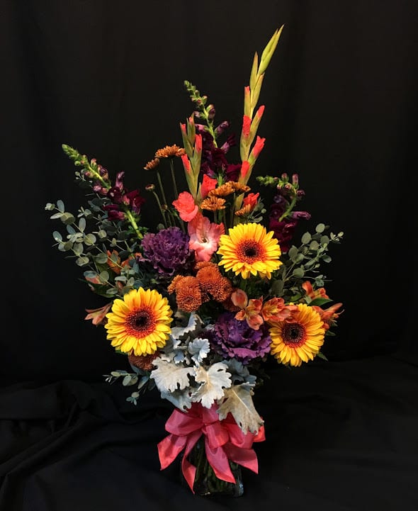 Tall mixed bouquet with yellow gerbera daisies in a vase