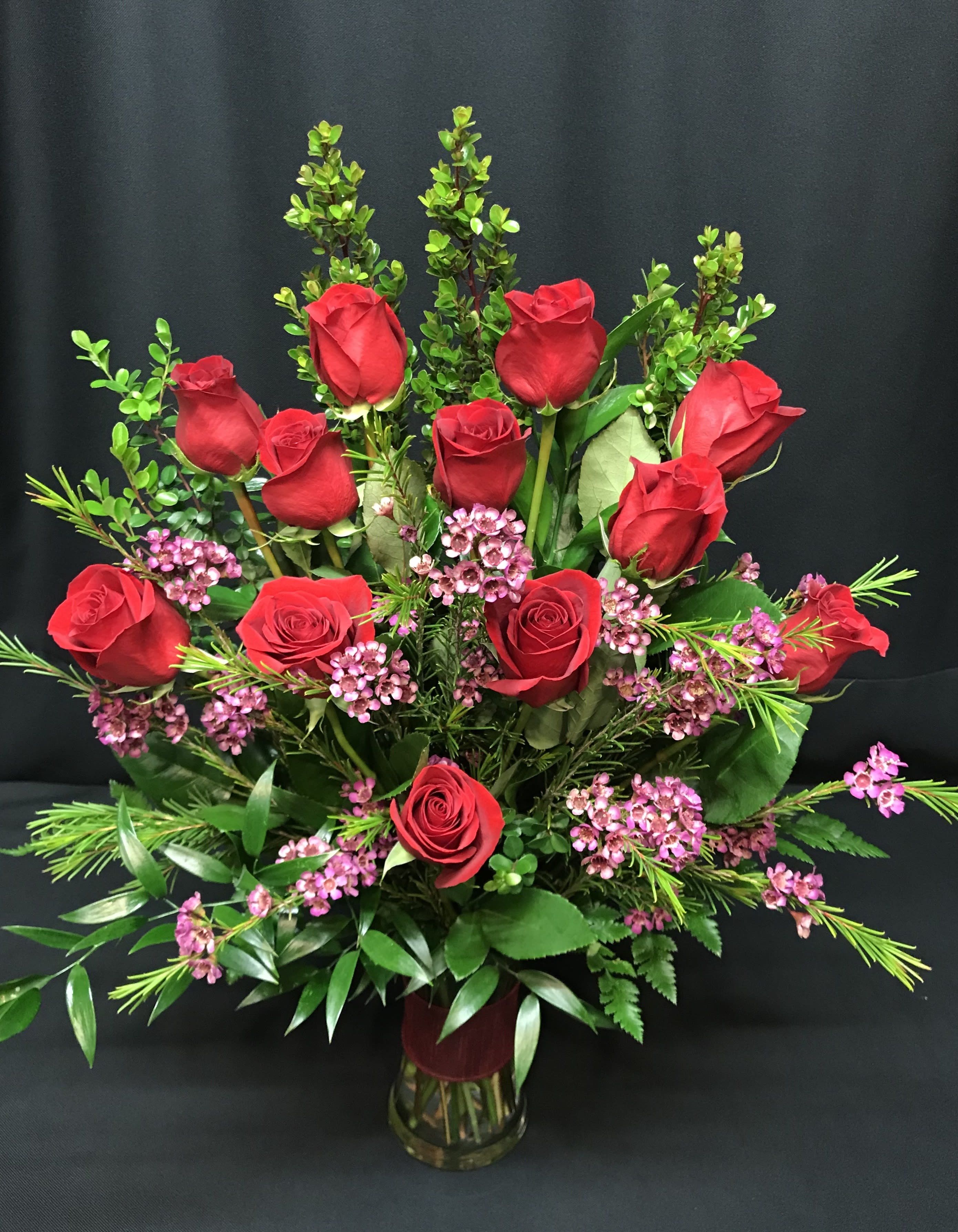 Dozen Medium Stem Roses in Gathering Vase - Red or Choose Colored  - RED Dozen unless  1) red is unavailable  This happens at times, especially when less than 1 week advance notice (3 week notice Valentine's day) is given on your order &amp; we will notify you if this is the case or  2) You Choose Colored.  (Write Colored Roses in the Special Requests section. We cannot guarantee a specific color with online orders)  Compare our medium stem roses to any other florist and you'll find ours are bigger, fresher and actually more affordable.  Includes filler flowers, lush greenery and vase. We deliver our roses completely arranged so there is no fuss to find scissors. All of this is included; there are no hidden costs for the best, most perfect roses you will find.  The roses we carry are Colombian roses and Ecuadorian roses, which are much bigger than California roses with a higher petal count.