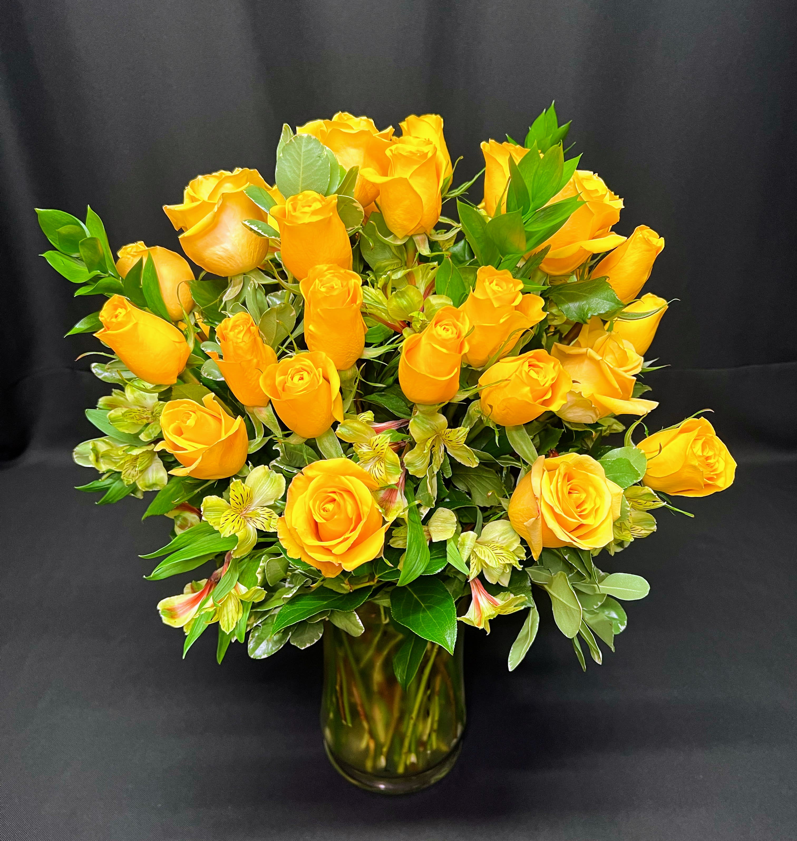 3 Dozen Medium Stem Roses, Red or Colored - 36 Roses in a full, round design. Design may vary. Order a Full Week ahead (3 weeks prior to Mother's day and Valentine's day) and specify 1st, 2nd and 3rd color choices in the Requests section. We will substitute any colors we need to when less time is given to prepare this arrangement.   Vase style and filler flowers and greens may vary. 