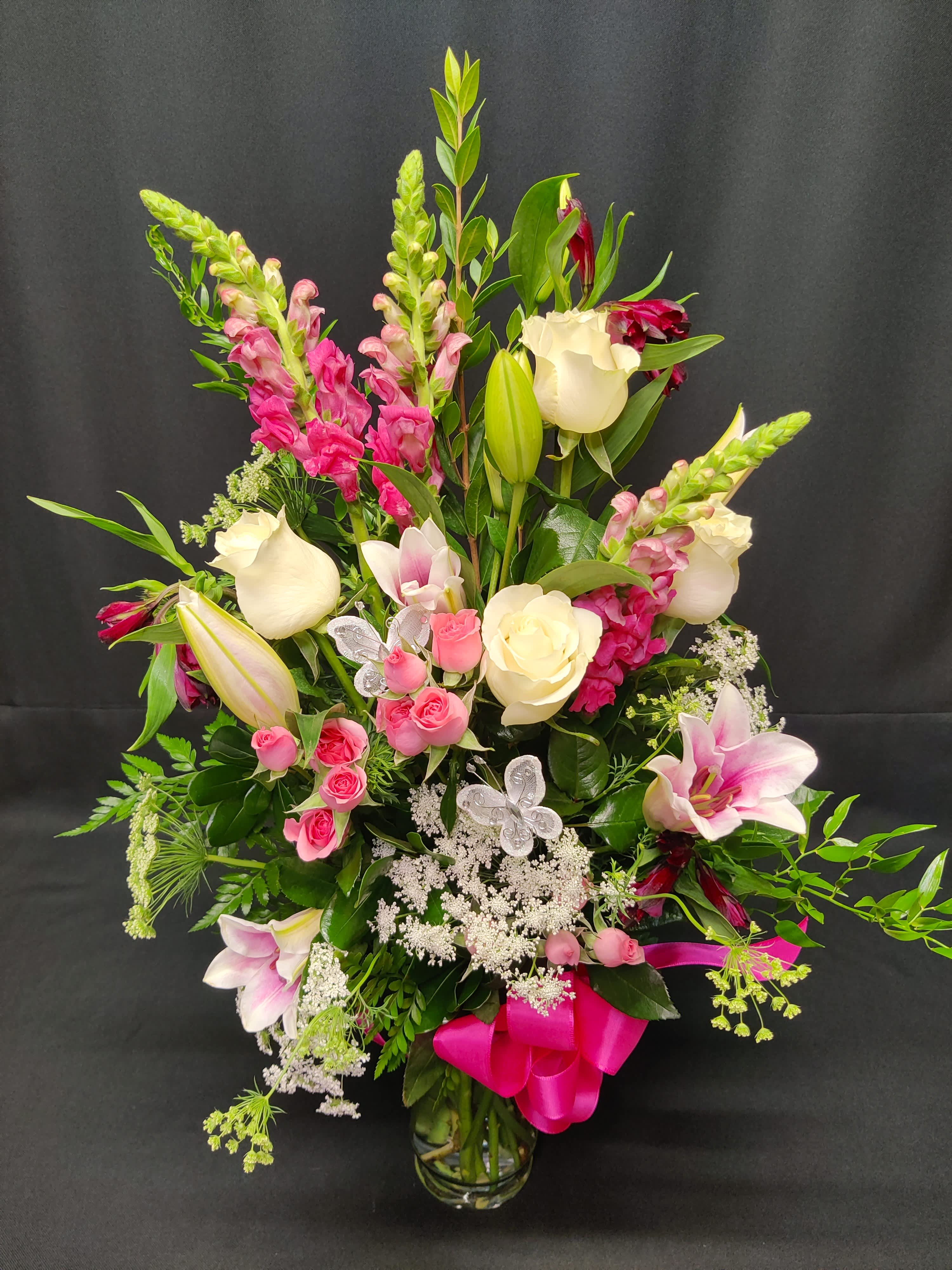 Oriental lilies with roses and butterflies - Fragrant Oriental lilies and a half dozen assorted style roses make an Impressive valentine or anniversary bouquet.  Absolutely memorable.  Tall and Impressive.  All premium assortments of filler and greenery. Assortment and Colors may vary.