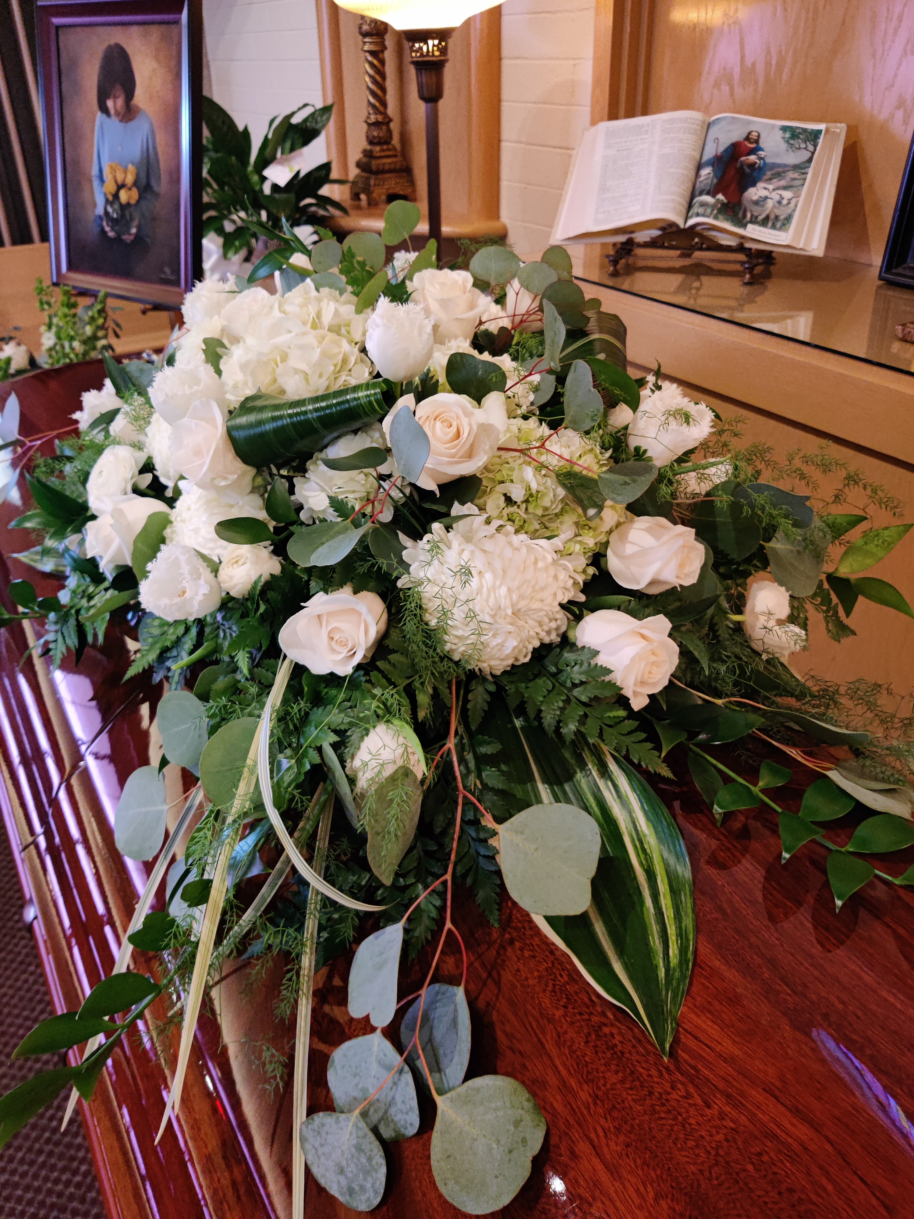 White floral casket spray with roses and hydrangea