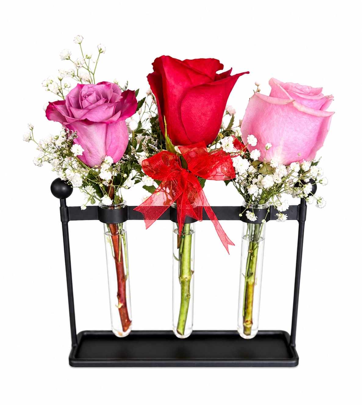 Three roses in glass tubes on a black stand with a red ribbon