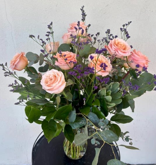 Peach Dozen - A dozen roses but make it peach. Complimented with greenery and filler. Large arrangement perfect for any special occasion. 
